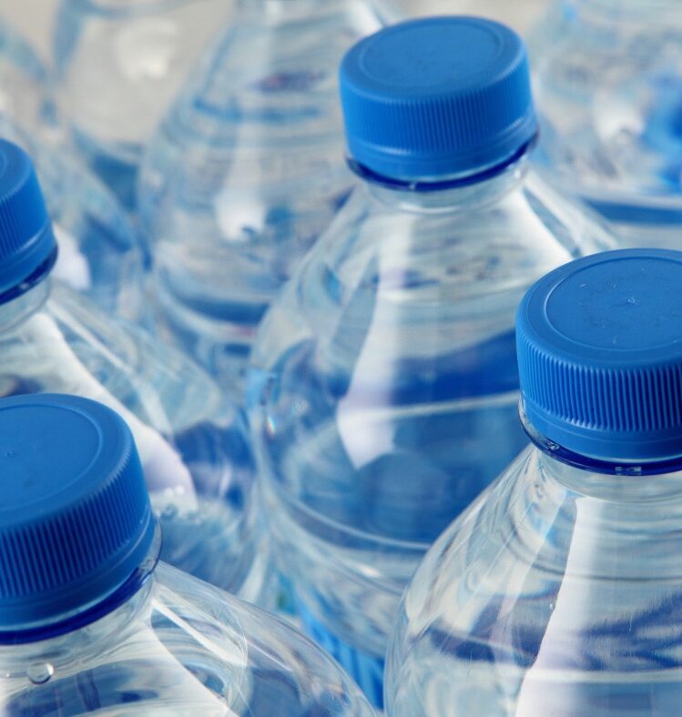 Bottles of water with blue lids ordered in lines