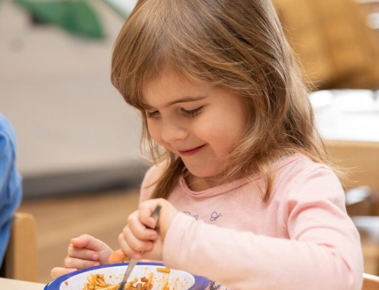 Young girl eating from a bowl
