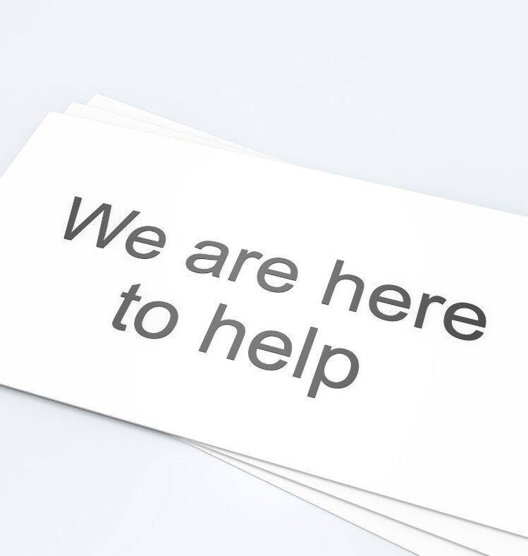 White paper sign saying we are here to help
