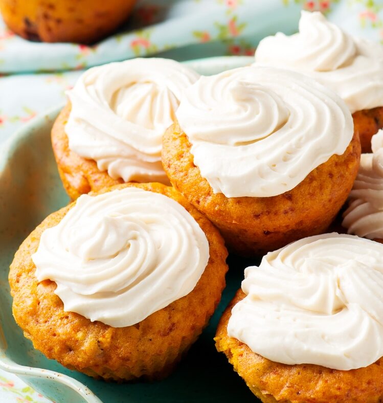 a stack of carrot cake muffins with icing on top