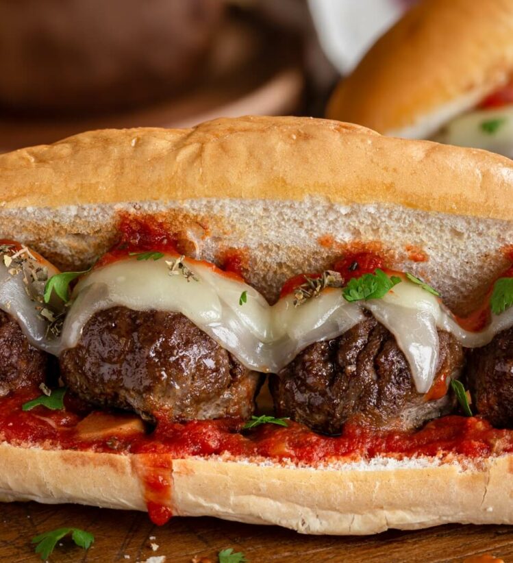 a Turkish bread sandwich with four meatballs, cheese, herbs and tomato sauce